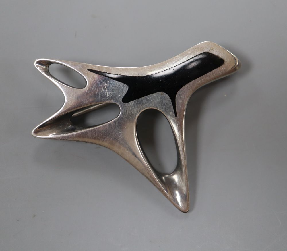 A post 1945 Henning Koppel for Georg Jensen sterling and black enamel modernist brooch, design no. 323, 58mm, gross 29 grams.